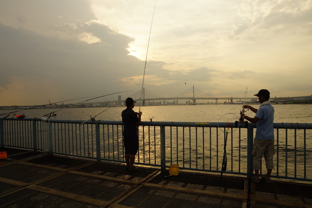 写真: 落日の釣り人